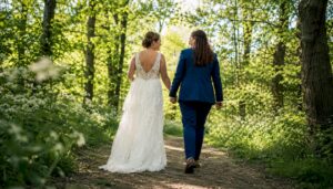 Same-sex couple walking on Sussex cliffs on wedding day